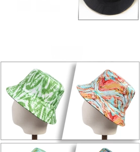 Detailed display of assorted tie-dye and solid black fisherman hats on mannequins