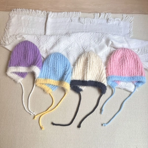 Kids plush winter earflap hats in four colors with warm knit ties and contrast trim