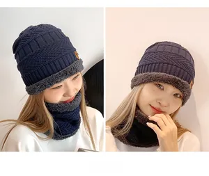 Detail showing the thick grey fleece lining inside the navy blue winter hat and neck gaiter