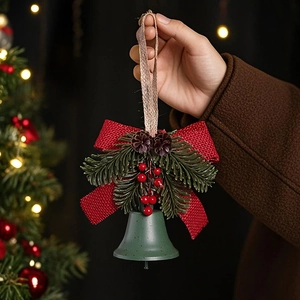 Detailed close-up of dark green Christmas bell with red bow and pine cone decoration
