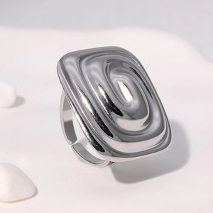 Close-up of a silver rectangular ring with ripple texture and an adjustable open band