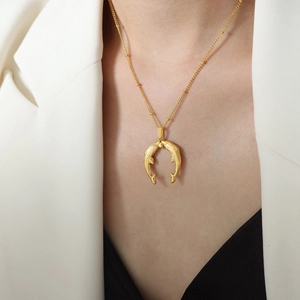 Golden titanium koi fish pendant necklace for women worn with a white blazer