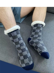 Detail view of blue and grey checkered knit floor socks with white fuzzy fleece lining