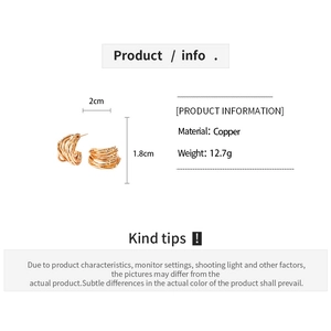 Detail view of gold-plated geometric twisted C-shape earrings with size measurements