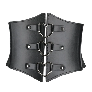 Close-up of three silver heart buckles and metal rivets on a black retro wide corset belt