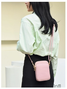Pink nylon mini crossbody phone bag with multi-layer zippers and woven shoulder strap