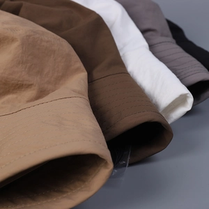 Detail of wide brim sun hats in five colors showing durable fabric and stitching