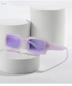 Detailed close-up of lavender square sunglasses with texture material and metal dots