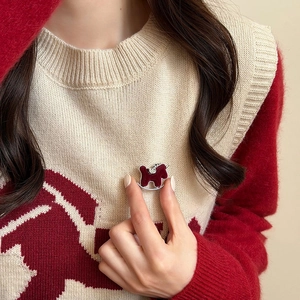 Vintage rote beflockte Schaukelpferd-Brosche mit Strasssteinen auf einem Strickpullover