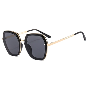 Fashionable hexagonal black sunglasses with gold metal frame for a modern minimalist look