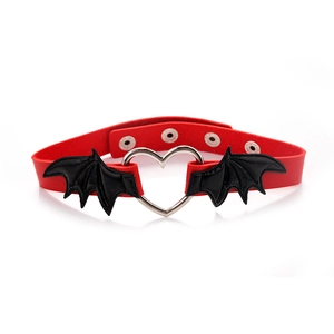 Detail showing red leather choker with black bat wings and silver heart metal ring