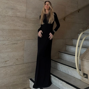 Elegant slim fit long sleeve black maxi dress for women on marble staircase