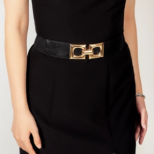 Detailed view of women's black elastic waist belt featuring a gold interlocking buckle