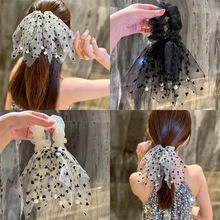 Detail of knitted flower hair claw clips with sheer mesh bows and pearl accents
