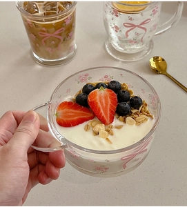 Tasse à petit-déjeuner en verre à fleurs avec poignée montrant yaourt et baies