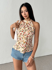Detailed close-up of floral halter top with backless design and light chiffon fabric