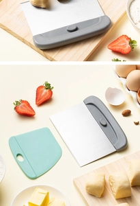 Macro detail of stainless steel scraper and plastic spatula set for dough on wooden board