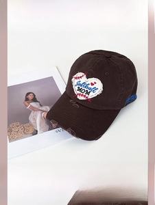 Detailed view of heart-shaped Softball MOM embroidery on dark brown distressed cap