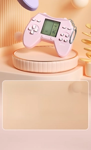 Pink mini handheld game console keychain with 26 game modes and dot matrix LCD screen