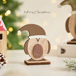 Wooden penguin Christmas tabletop ornament with a Santa hat for festive home decoration