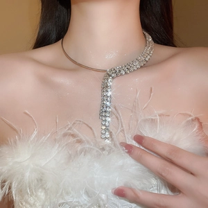 Close-up of elegant silver tassel choker with three rows of shimmering rhinestones