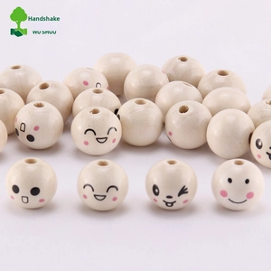 Macro shot of 20mm natural wood beads with printed emoji faces for DIY craft projects