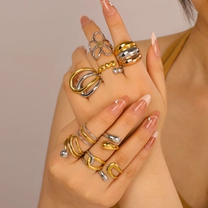 Two-tone intertwined hollow gold and silver stainless steel rings worn by a model