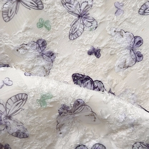 Close-up of lace butterfly pattern with soft textured faux fur on a large shoulder bag