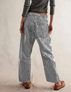 Rear view of striped wide-leg pants showing the back pockets and grey drawstring waist
