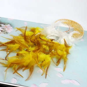 Detailed view of soft yellow and white feathers with beads for tree of life dream catcher
