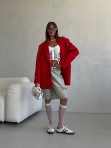 Women's red blazer with rhinestone heart design and long sleeves in a stylish casual outfit