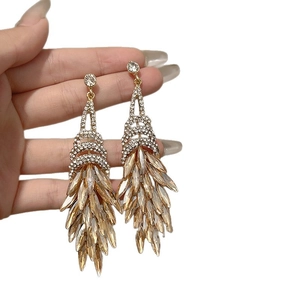 Exaggerated champagne gold tassel earrings with glittering diamonds for party wear
