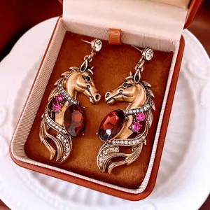 Vintage horse head earrings with red crystal pendant and rhinestones in bronze finish