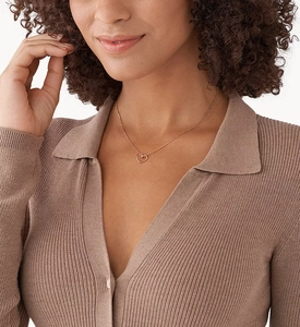 Close-up of elegant rose gold hollow heart pendant necklace worn by a model