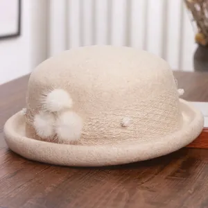 Elegant beige wool felt cloche hat with mesh veil and pompom details for women