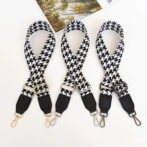 Three adjustable houndstooth bag straps with gold, silver, and gunmetal hooks