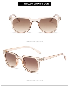 Close-up of translucent shallow brown square sunglasses with gradient lenses and metal hinges