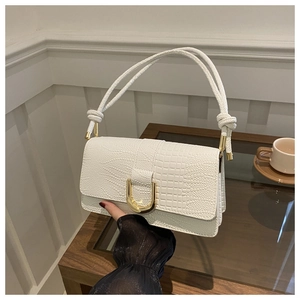 White faux leather crocodile pattern crossbody bag with golden U-shaped clasp and knotted strap