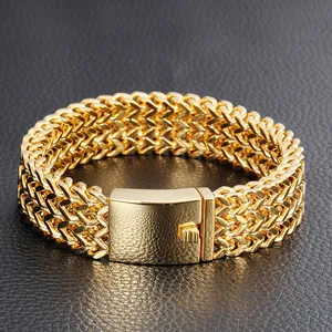 Close-up detail of a heavy gold stainless steel Franco link bracelet with square box clasp