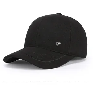 Detail view of the black wool blend baseball cap with a sleek grey metal triangle logo