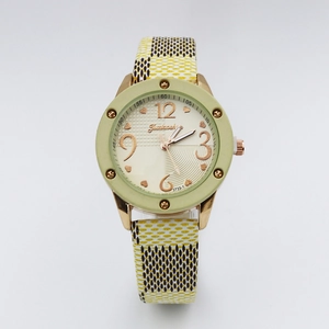 Close-up of vintage quartz watch with green case and stylish plaid fabric strap