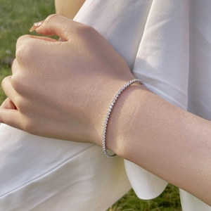 Close-up of elegant S925 silver tennis bracelet with 2mm round zircons on model's wrist