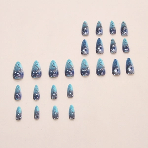 Blue stary night press-on nails with celestial moon and star designs for women