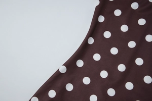 Détail du tissu à pois marron foncé avec texture lisse pour robe de style français