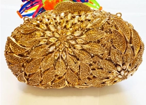 Macro shot of gold leaf clutch bag with sparkling floral crystal rhinestone patterns