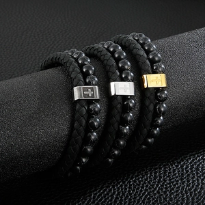Detail of men's double-layer black stone bead and leather bracelet with cross clasp