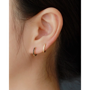 Close-up of S925 silver hoop earrings with micro-set black and clear zircon stones