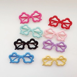 Flat lay of colorful flower-shaped kids sunglasses in eight bright pastel color options