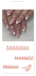 Detail of 3D pink floral short almond press-on nails with pearl accents and gradient finish