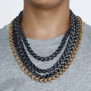 Detail of punk style multi-layer skull chain necklace in gold and gunblack stainless steel